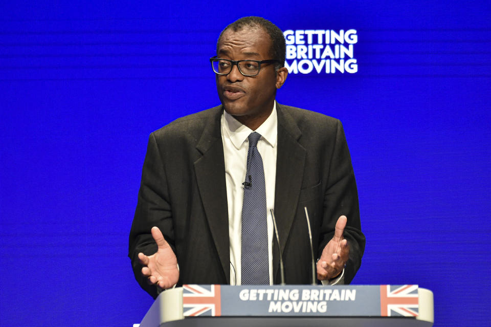 Britain's Chancellor of the Exchequer Kwasi Kwarteng speaks at the Conservative Party conference at the ICC in Birmingham, England, Monday, Oct. 3, 2022. The British government has dropped plans to cut income tax for top earners, part of a package of unfunded cuts that sparked turmoil on financial markets and sent the pound to record lows. (AP Photo/Rui Vieira)