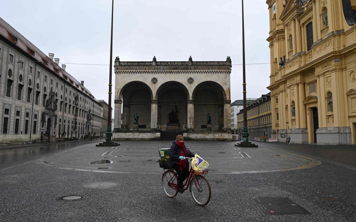 A cyclist pases Odeonsplatz in the city of Munich, southern Germany, on March 21, 2020. - The public life in the city is very limited due to the coronavirus COVID-19. (Photo by Christof STACHE / AFP) (Photo by CHRISTOF STACHE/AFP via Getty Images) - CHRISTOF STACHE/AFP