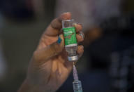 A doctor fills a syringe with a vial of the Covishield COVID-19 vaccine at a vaccination center in Mumbai, India, Thursday, Sept. 23, 2021. (AP Photo/Rafiq Maqbool)