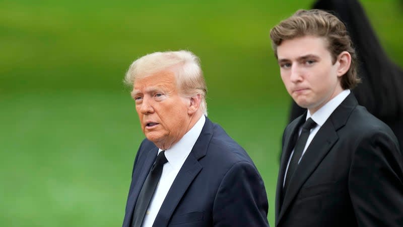 Former President Donald Trump, left, arrives with his son Barron for the funeral of the former first lady's mother at the Church of Bethesda-by-the-Sea in Palm Beach, Fla., Thursday, Jan. 18, 2024.