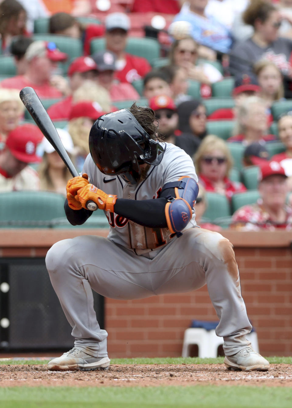 Detroit Tigers' Eric Haase loses his helmet as he ducks to avoid a pitch from St. Louis Cardinals' Drew VerHagen in the sixth inning of a baseball game, Saturday, May 6, 2023, in St. Louis. (AP Photo/Tom Gannam)