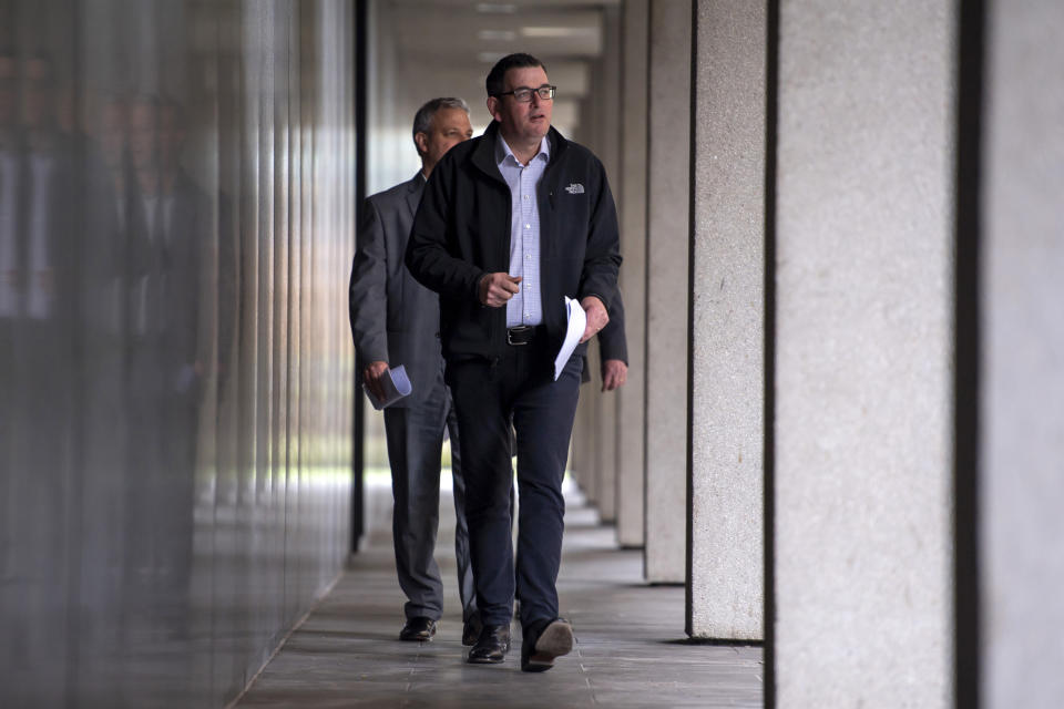 Victorian Premier Daniel Andrews walks to a press conference in Melbourne, Monday, July 6, 2020. As Australia is emerging from pandemic restrictions, the Victoria state capital Melbourne is buckling down with more extreme and divisive measures that are causing anger and igniting arguments over who is to blame as the disease spreads again at an alarming rate. (AP Photo/Andy Brownbill)