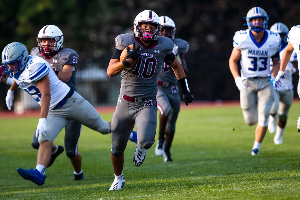 Mishawaka’s Ethan Bryce (10) runs the opening kickoff for a touchdown during the Mishawaka vs. Marian high school football game Friday, Aug. 18, 2023 at Mishawaka High School.