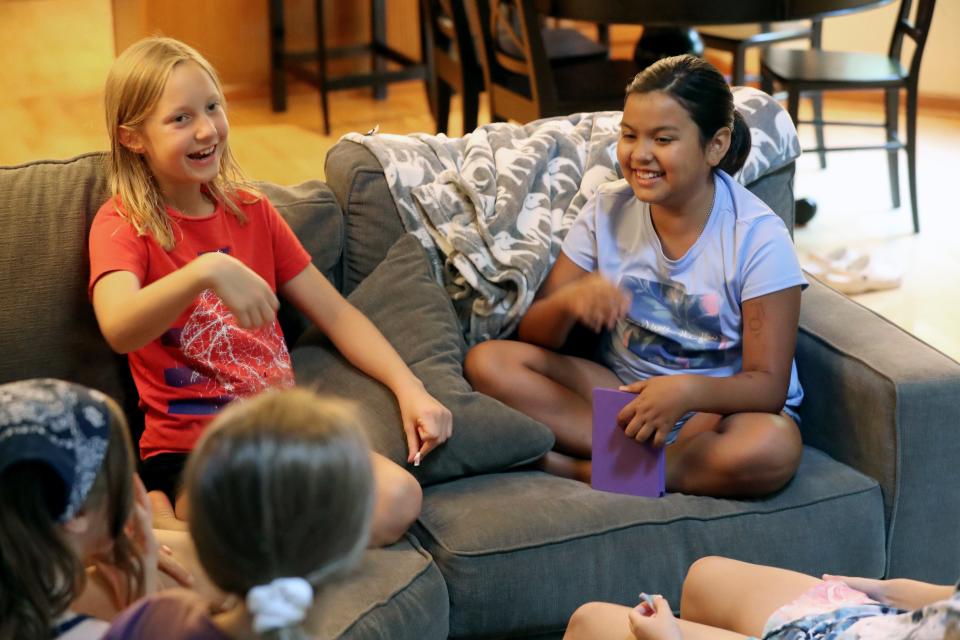 High Point students Priya Vyas (right) and Everly Hannah, both 9, laugh during their June 23 book club meeting.