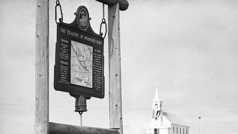 This undated file photo shows the historical marker commemorating the Wounded Knee Massacre of 1890 on the road near the Sacred Heart Catholic Church in Wounded Knee, S.D.