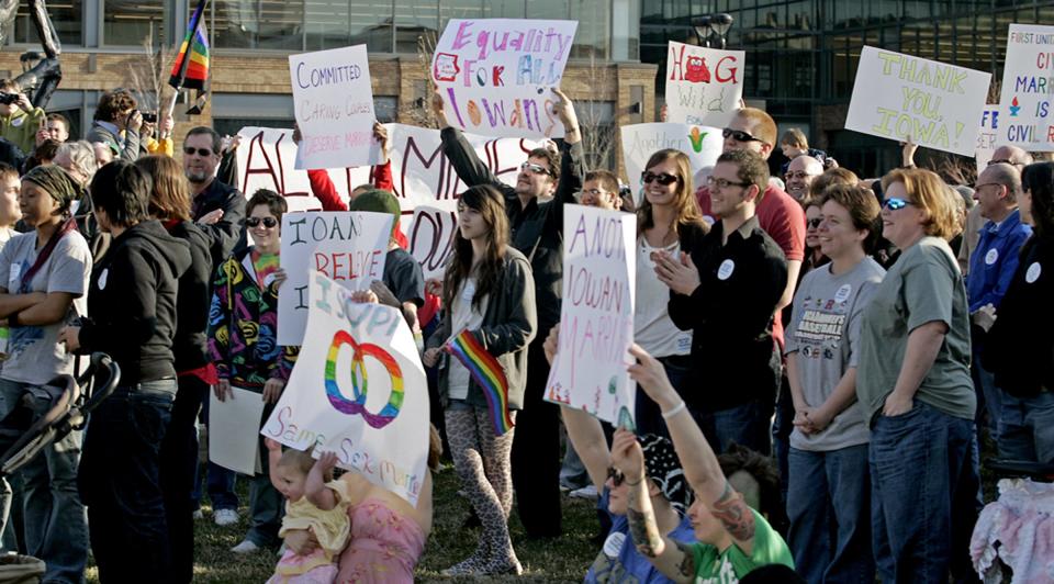 Members of a crowd applaud and hold up signs at a One Iowa rally at Western Gateway Park in Des Moines on April 3, 2009. The rally was held to celebrate the Iowa Supreme Court's unanimous decision in Varnum v. Brien, which legalized same-sex marriage across the state.