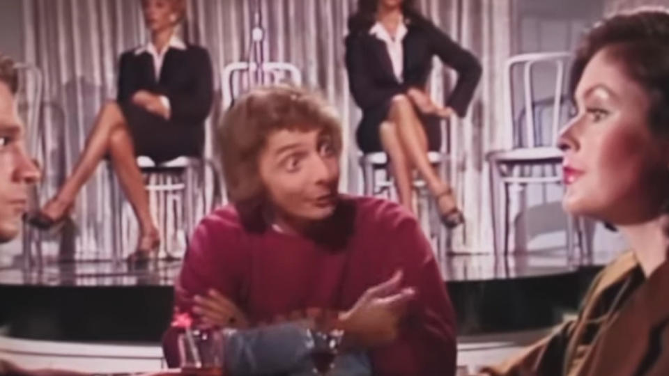 Barry Manilow making a weird face at a nightclub table in Copacabana