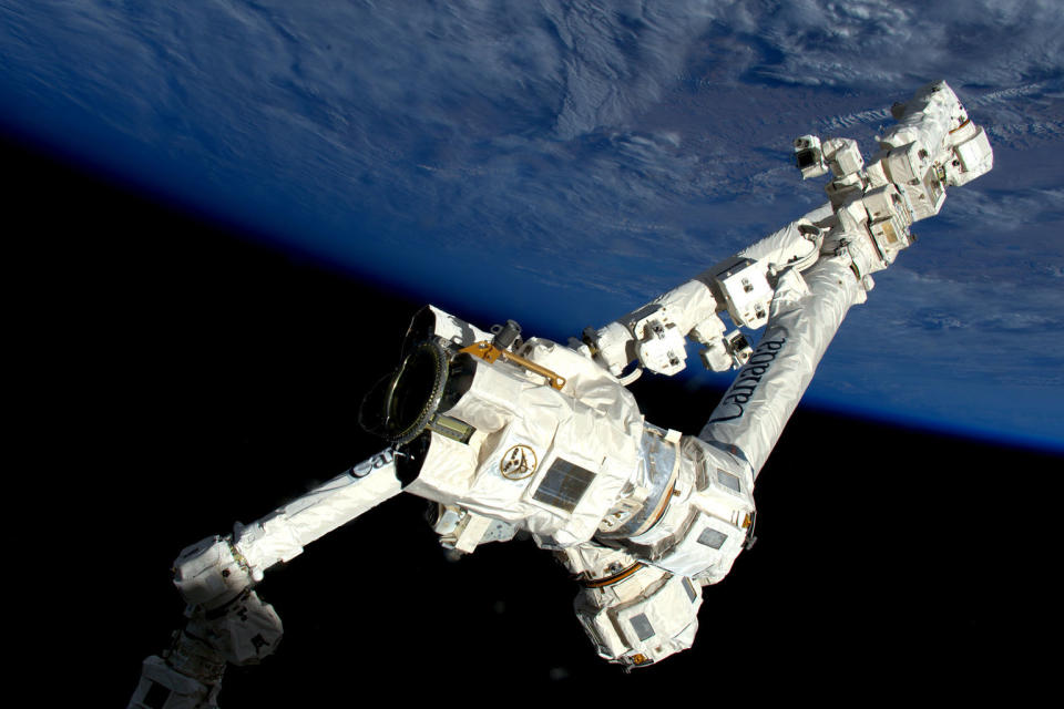A view of the Canadarm2 robotic arm, with a latching end effector in the foreground. <cite>ESA/NASA</cite>