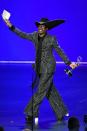 <p>Collecting his Emmy for Best Lead Actor in a drama series for Pose (and becoming the first, gay, black man to do so), Porter wore a custom Michael Kors pinstripe suit with platform shoes, a Stephen Jones custom hat an extra-long scarf as a tie. </p><p>The actor explained that he wanted a '70s disco throwback moment' with his attire to <a href="https://www.hollywoodreporter.com/news/pose-star-billy-porter-what-ill-be-wearing-at-emmys-1240439" rel="nofollow noopener" target="_blank" data-ylk="slk:The Hollywood Reporter;elm:context_link;itc:0;sec:content-canvas" class="link ">The Hollywood Reporter</a>.</p>