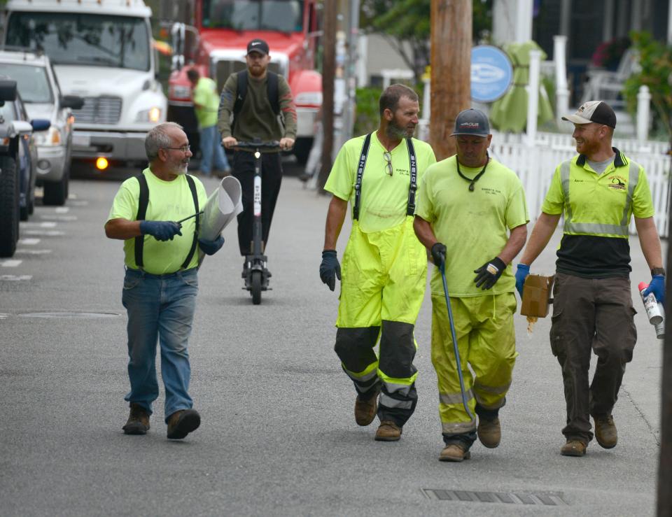 Workers from Robert B. Our make their way up Commercial Street  in Provincetown on Friday as Provincetown town officials and Woodard and Curran sewer operator dealt with a sewer emergency. A storm earlier in the week knocked out the vacuum pump system that serves the downtown area, according to town officials.