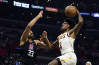 Cleveland Cavaliers guard Collin Sexton (2) goes up for a dunk over Los Angeles Clippers forward Nicolas Batum (33) during the first half of an NBA basketball game Wednesday, Oct. 27, 2021, in Los Angeles. (AP Photo/Marcio Jose Sanchez)