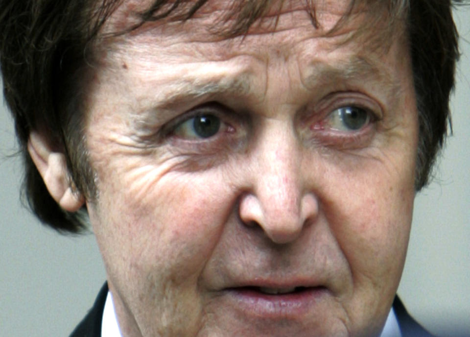 FILE -This Monday March 17, 2008 file photo shows Paul McCartney, 65, leaving the central London's Royal Courts of Justice, following the announcement of the judgment of his divorce with Heather Mills. On Tuesday, July 24, 2012, British prosecutors announced charges against eight people alleged to have been involved in a phone hacking scheme with more than 600 targets. Some of the prominent alleged victims of the phone hacking are thought to have included, Paul McCartney, Heather Mills, Angelina Jolie, Brad Pitt, Jude Law, Sadie Frost, Sienna Miller, Wayne Rooney, Sven-Goran Eriksson, Lord Frederick Windsor, John Prescott, as well as murdered 13-year old school girl who was abducted in 2002 Amanda "Milly" Dowler. (AP Photo/Lefteris Pitarakis, file)
