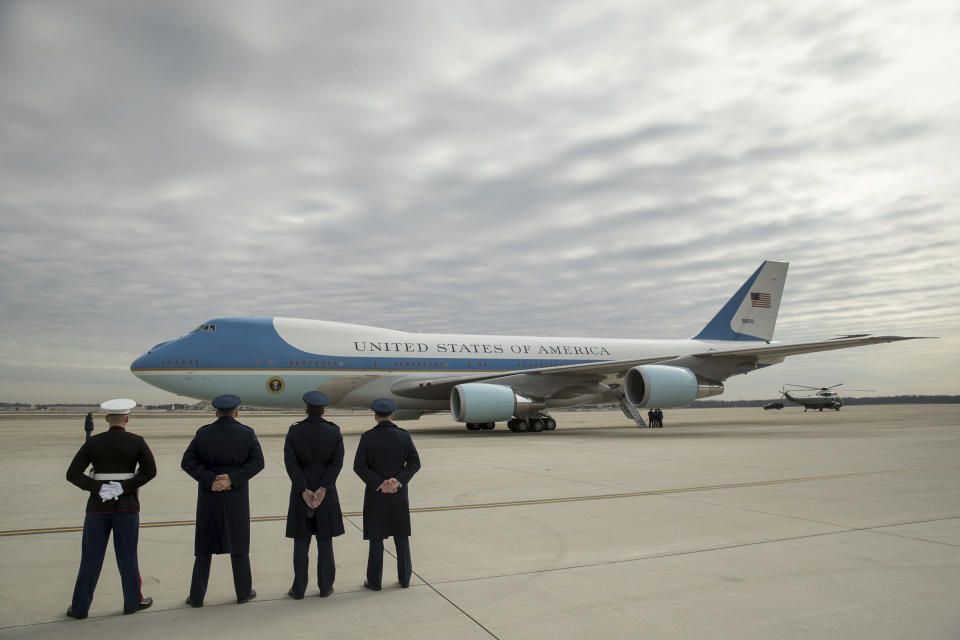FILE - Military personnel watch as Air Force One, with President Donald Trump, aboard prepares to depart at Andrews Air Force Base in Md., Friday, Feb. 17, 2017. After more than half a century, Boeing is rolling its last 747 out of a Washington state factory on Tuesday night. The jumbo jet, which has been used as a cargo plane, a commercial aircraft capable of carrying nearly 500 passengers and as Air Force One, debuted in 1969. (AP Photo/Andrew Harnik, File)