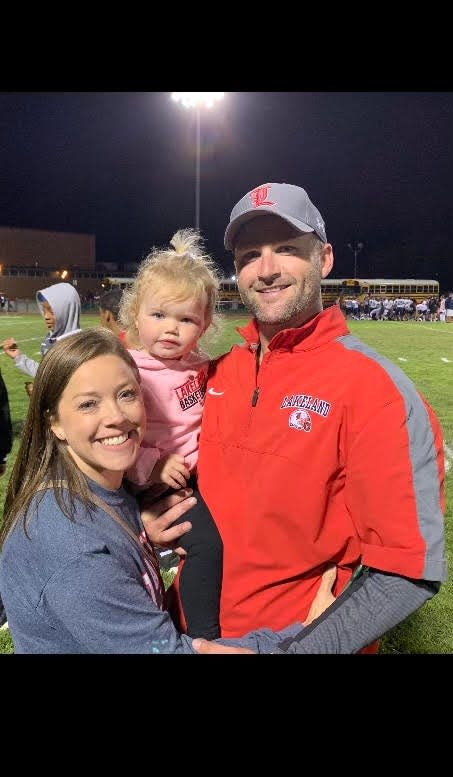 Ryan McCarney, right, was named head football coach at Lakeland Tuesday night. This is McCarney and his wife Danielle and young daughter.