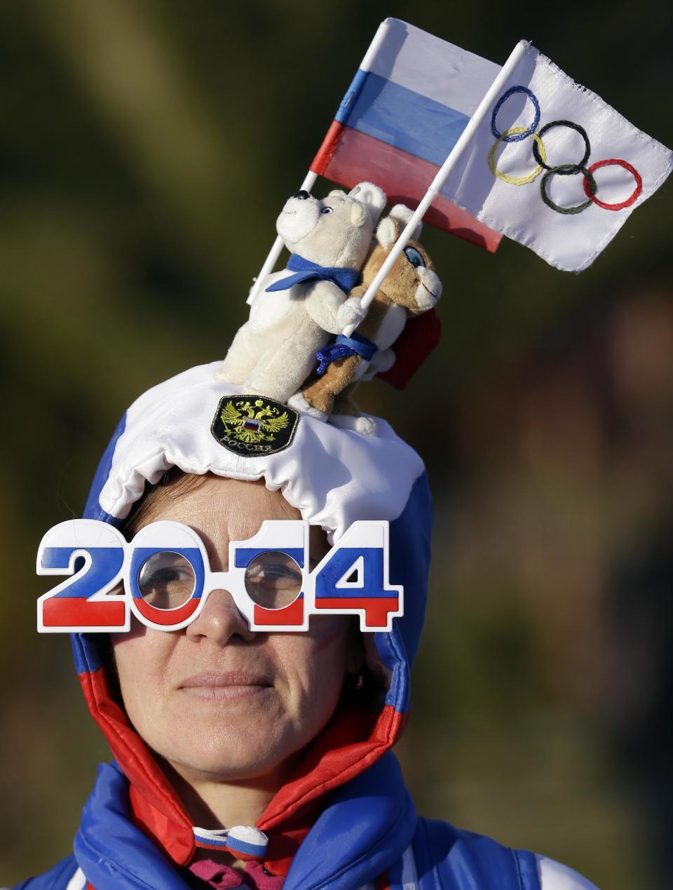 A fan makes her way through the Olympic Park at the 2014 Winter Olympics, Wednesday, Feb. 12, 2014, in Sochi, Russia. (AP Photo/Morry Gash)