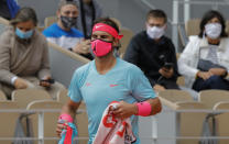 Spain's Rafael Nadal walks to his bench during a break in the second round match of the French Open tennis tournament against Mackenzie McDonald of the U.S. at the Roland Garros stadium in Paris, France, Wednesday, Sept. 30, 2020. (AP Photo/Christophe Ena)