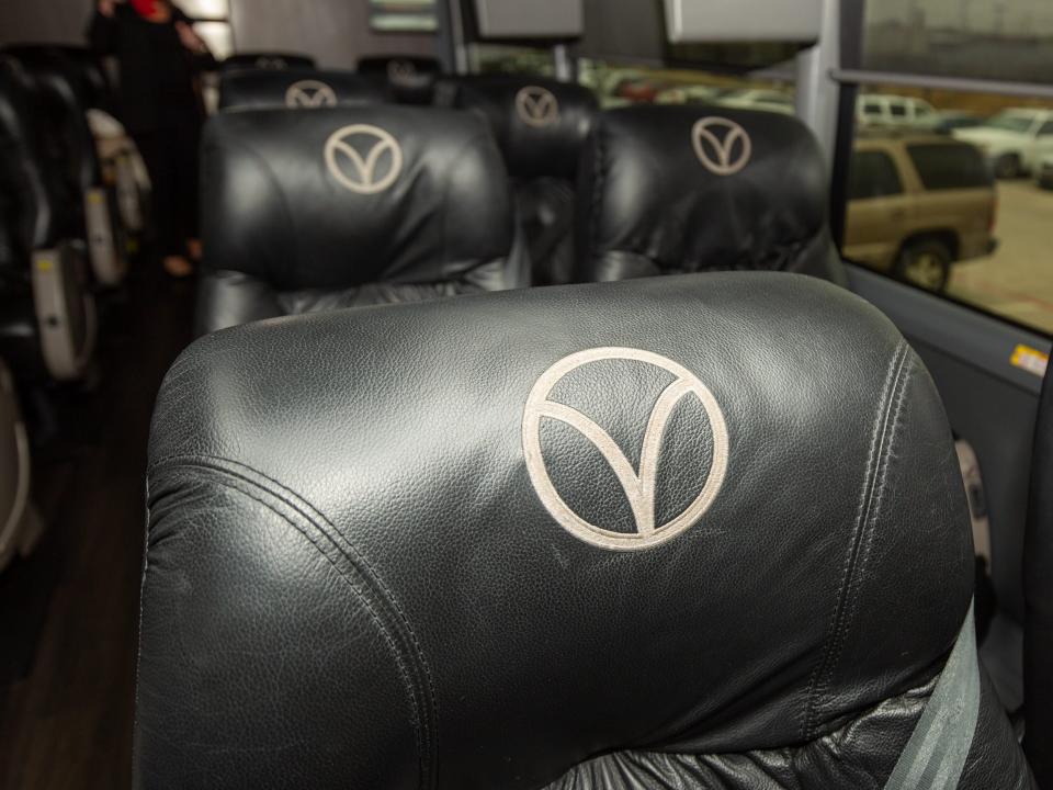 A close up of the Vonlane logo on plush black seats.