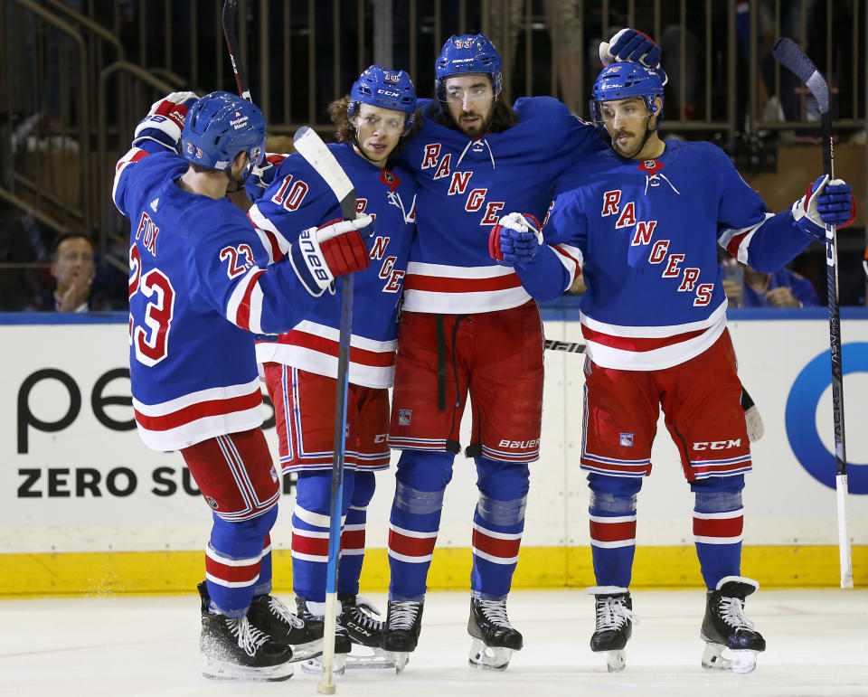 From left to right, New York Rangers players Adam Fox, Artemi Panarin, Mika Zibanejad and Vincent Trocheck celebrate after Zibanejad's goal during the first period of an NHL hockey game against the Detroit Red Wings, Sunday, Nov. 6, 2022, in New York. (AP Photo/John Munson)
