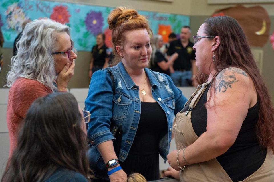Teacher Carrie Molaug, right, who was supervising the field trip where five children were struck in a crosswalk by a van, speaks with two relatives of seriously injured preschooler Juniper, 4, at a community meeting on Monday at Pinewood Elementary in Pollock Pines. Nichole Traverse, left, is Juniper’s grandmother and Alison Warren, center, is Juniper’s aunt.