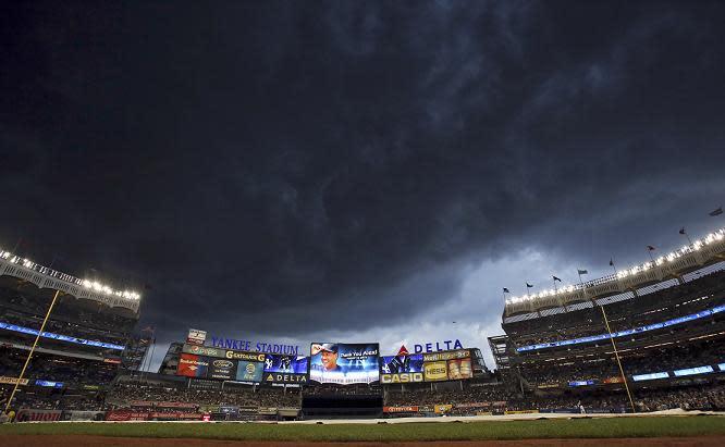 Storm clouds move over Yankee Stadium during a ceremony for New York Yankees' Alex Rodriguez. (AP)