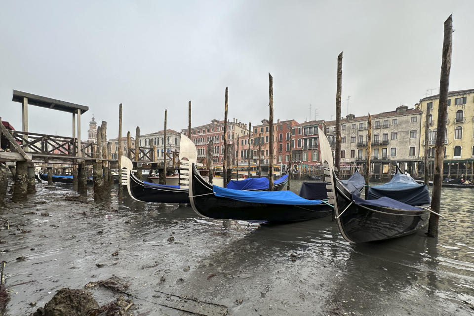 Gondolas are docked along a canal during a low tide in Venice, Italy, Saturday, Feb. 18, 2023. Some ofVenice's secondary canals have practically dried up lately due a prolonged spell of low tides linked to a lingering high-pressure weather system. (AP Photo/Luigi Costantini)