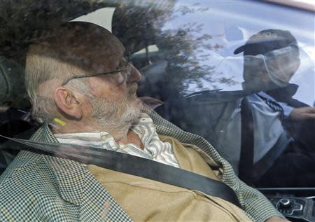 Jean-Claude Mas (L), founder of French company Poly Implant Prothese (PIP), leaves the Marseille's court December 10, 2013. The founder of a French breast implant company was sentenced to four years in prison by a Marseille criminal court on Tuesday for hiding the true nature of the sub-standard silicone used in implants sold to 300,000 women around the world. REUTERS/Jean-Paul Pelissier