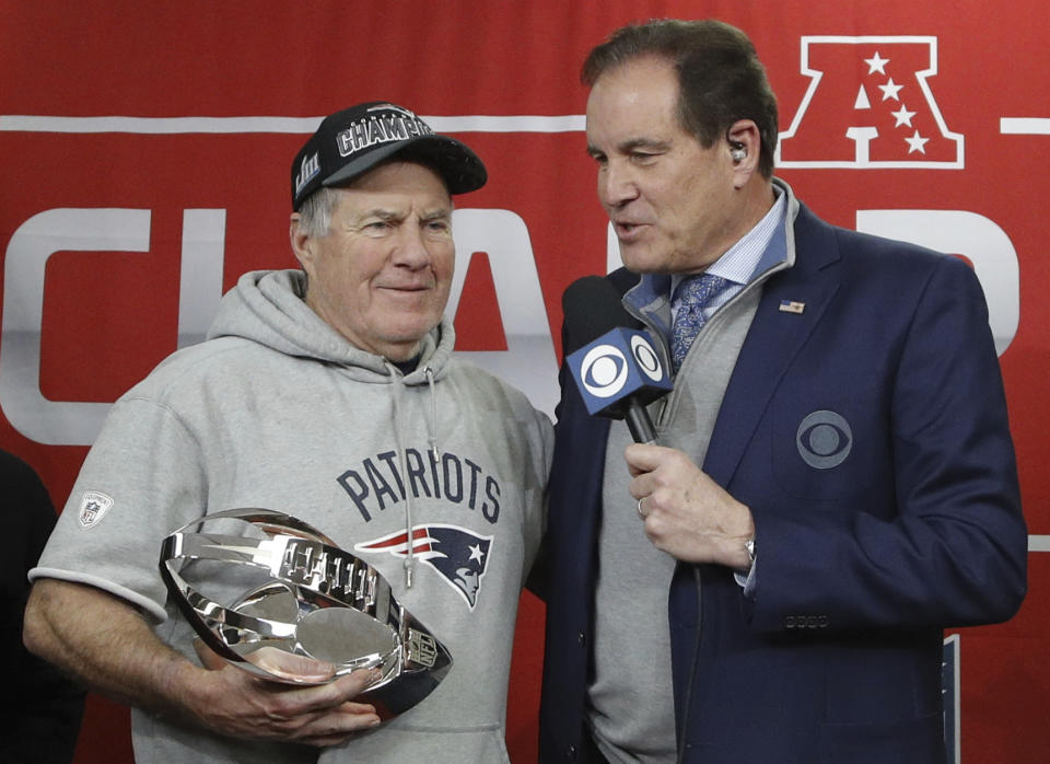 New England Patriots head coach Bill Belichick holds the AFC Championship trophy as he talks with Jim Nantz after defeating the Kansas City Chiefs the AFC Championship NFL football game, Sunday, Jan. 20, 2019, in Kansas City, Mo. (AP Photo/Charlie Riedel)