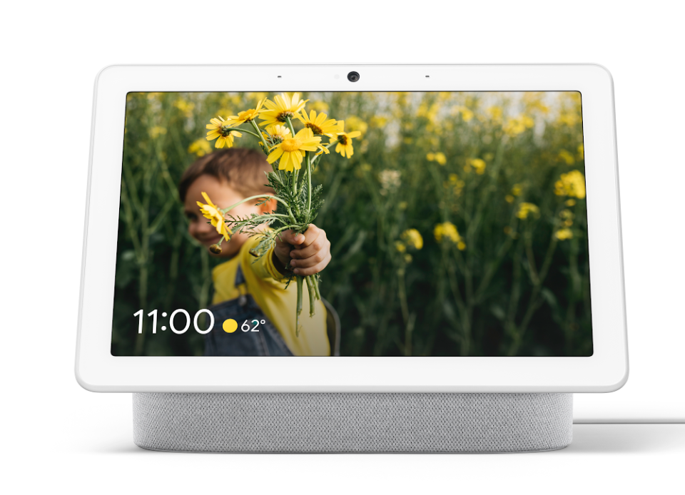 Google Nest Hub with photo on the screen of a little boy with daisies in his hand