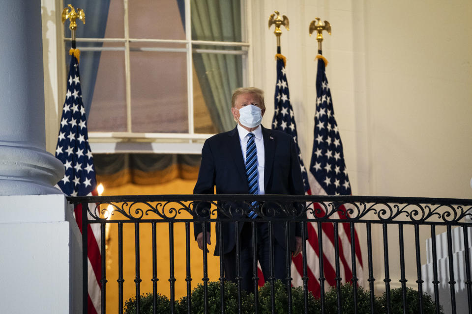 WASHINGTON, DC - OCTOBER 5: President Donald J. Trump wearing a face mask watches Marine One from the Truman Balcony as he returns home after receiving treatments for the covid-19 coronavirus at Walter Reed National Military Medical Center, at the White House on Monday, Oct 05, 2020 in Washington, DC. (Photo by Jabin Botsford/The Washington Post via Getty Images)