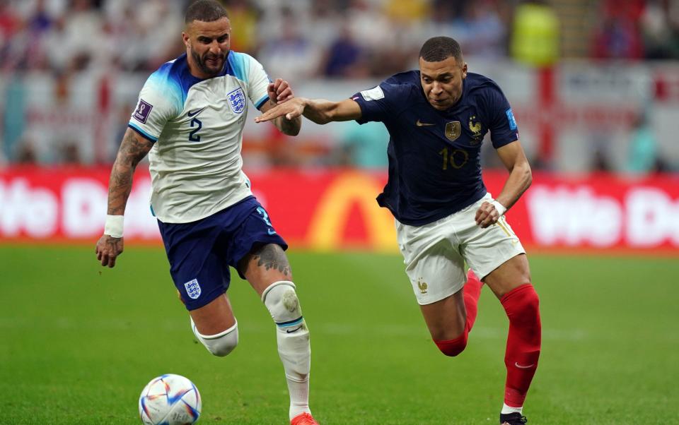 England's Kyle Walker and France's Kylian Mbappe (right) battle for the ball during the FIFA World Cup Quarter-Final match at the Al Bayt Stadium in Al Khor, Qatar - PA