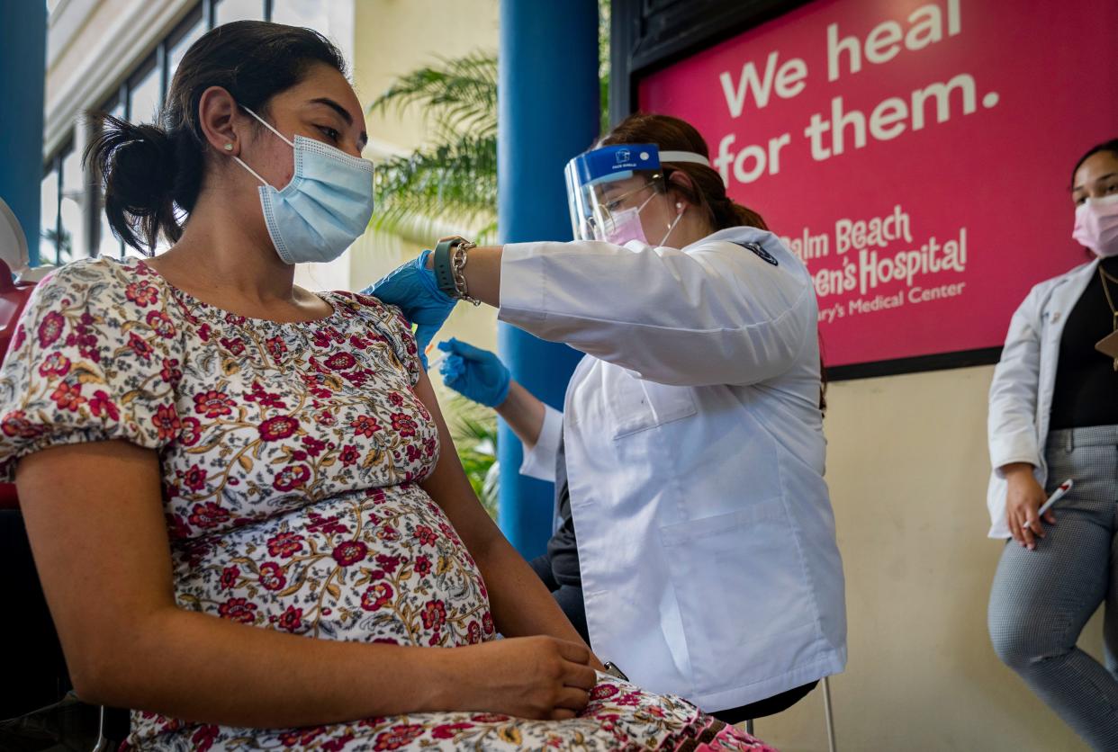 Yohane Matuce receives her first shot of the Pfizer COVID-19 vaccine from Gabriela Bermudez-Capo during "Play date to vaccinate" for pregnant women to get vaccinated at Palm Beach Children's Hospital at St. Mary's Medical Center in West Palm Beach, Florida on August 31, 2021. 