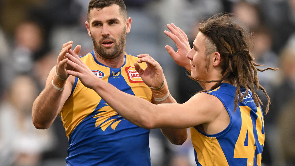Jack Darling is congratulated by a West Coast Eagles teammate after kicking a goal.