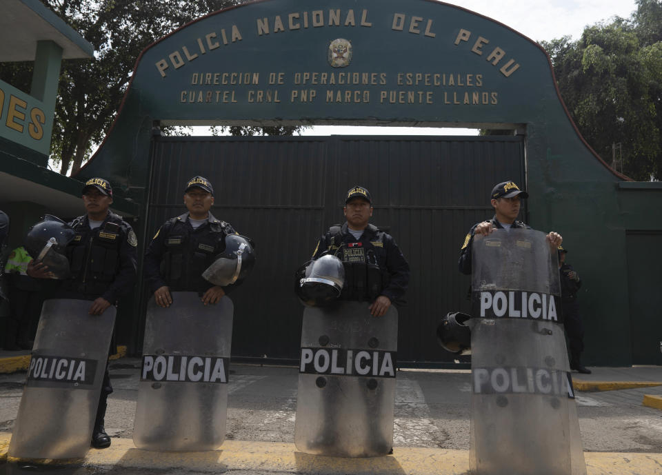 Police stand guard outside the National Police base where ousted President Pedro Castillo is held for a hearing, facing charges of rebellion, on the outskirts of Lima, Peru, Tuesday, Dec. 13, 2022. Castillo was detained on Dec. 7 after he was ousted by lawmakers when he sought to dissolve Congress ahead of an impeachment vote. (AP Photo/Guadalupe Pardo)