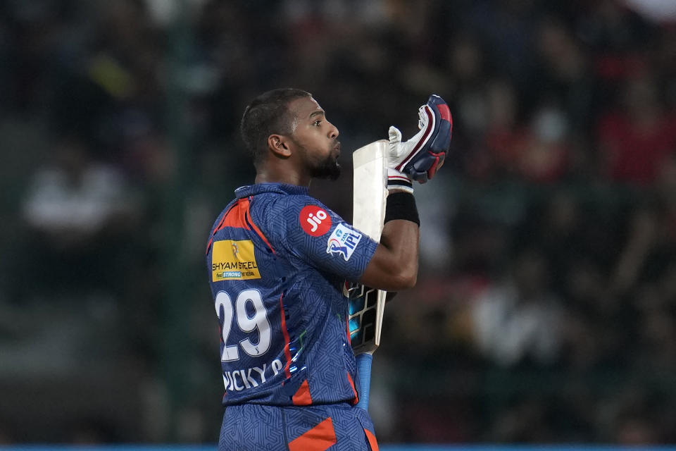 Lucknow Super Giants' Nicholas Pooran blows a kiss to celebrate scoring fifty runs during the Indian Premier League cricket match between Royal Challengers Bangalore and Lucknow Super Giants in Bengaluru, India, Monday, April 10, 2023. (AP Photo/Aijaz Rahi)