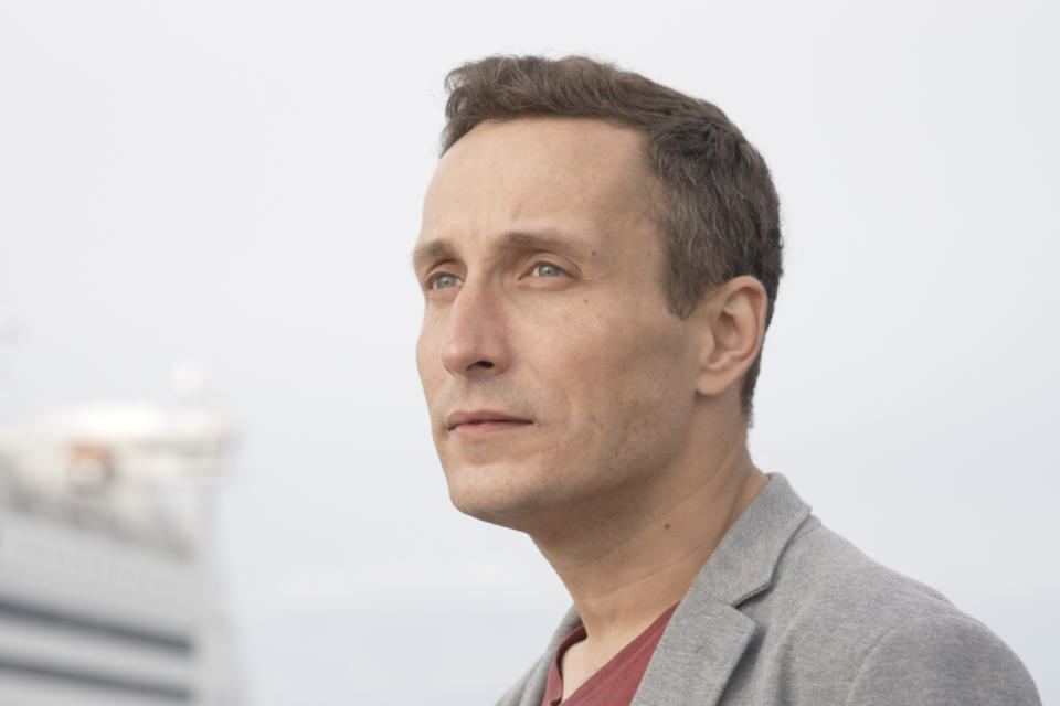 Ivan Zavrazhnov stands near a ferry where he is living now in Tallinn, Estonia. A producer for a pro-Ukrainian television network in Mariupol, he made it through a Russian-controlled filtration point only because officials never bothered to plug in his dead cell phone. He escaped to Belarus, then Poland, then Estonia, leaving Russia behind with great relief. (AP Photo/Vasilisa Stepanenko)