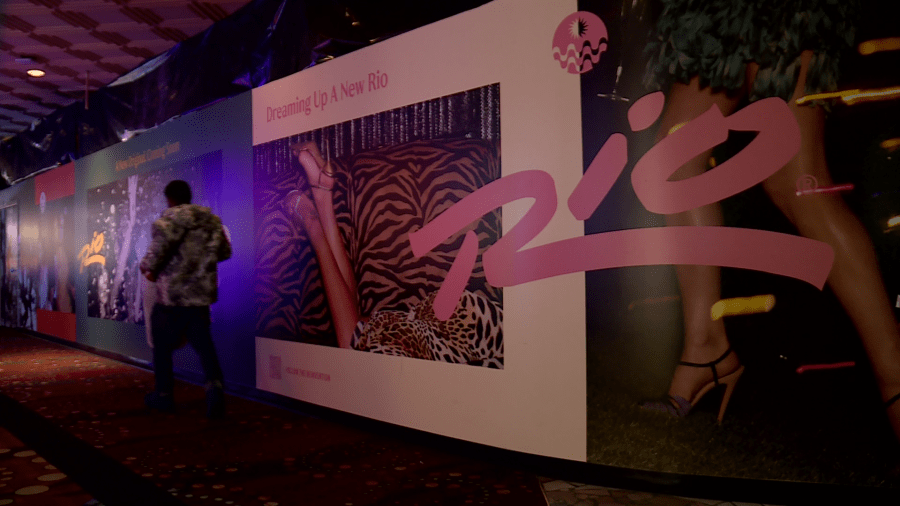 A guest walks past walls that conceal construction inside The Rio’s gaming floor and lobby. (KLAS)