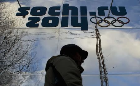 A man walks past a shop with an Olympic logo in the Black Sea resort town of Sochi December 21, 2013. REUTERS/Maxim Shemetov