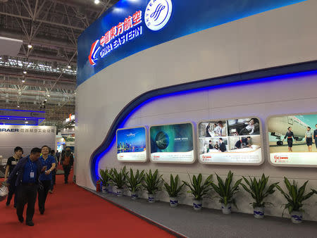 People walk past a booth of China Eastern Airline at an air show, the China International Aviation and Aerospace Exhibition, in Zhuhai, Guangdong Province, China, November 3, 2016. Picture taken November 3, 2016. REUTERS/Brenda Goh