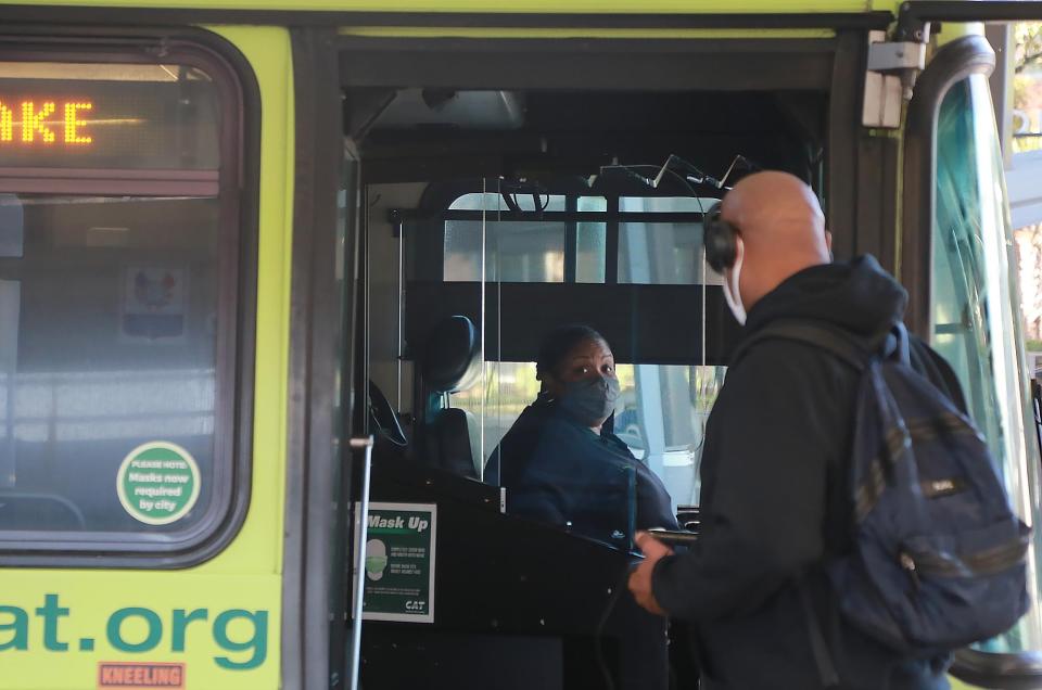 A driver talks with a passenger as he boards a bus at the Chatham Area Transit Joe Murray Rivers, Jr. Intermodal Transit Center.