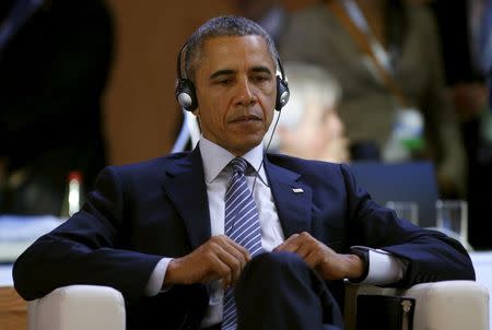 U.S. President Barack Obama, seated just offstage, awaits his turn to speak during the COP21 session of statements by heads of state and government at the climate summit in Paris, France November 30, 2015. REUTERS/Kevin Lamarque