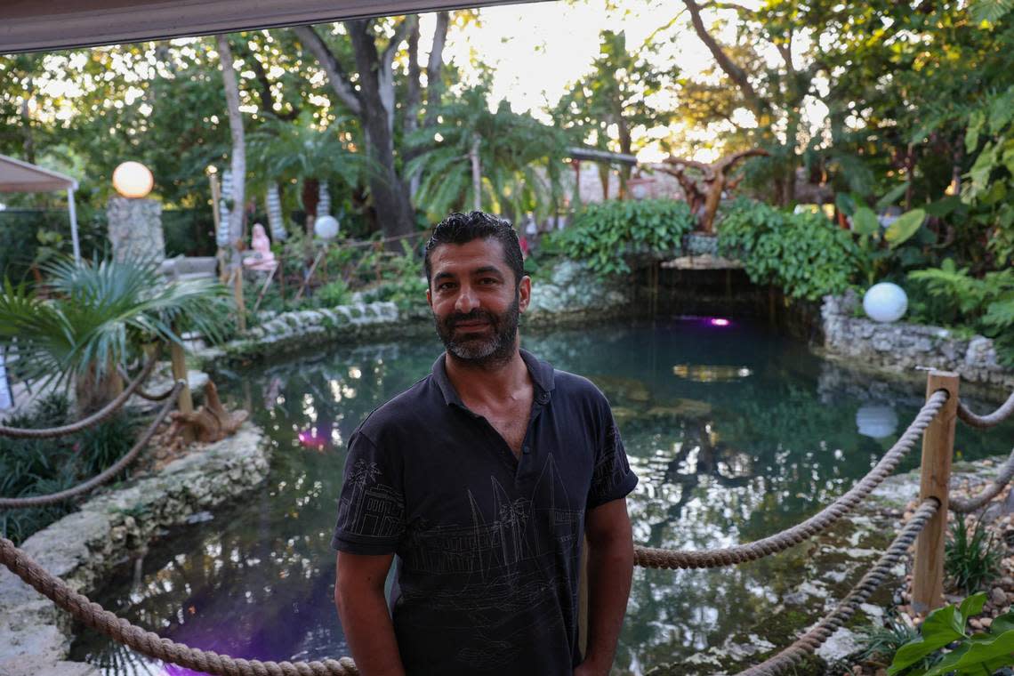 Ahmet Demir poses in front of the fountain behind his restaurant, ZOI, which is housed in a former pump house built in 1923 for the Bay Shore subdivision.