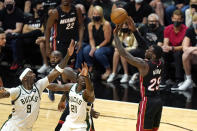 Miami Heat guard Kendrick Nunn (25) shoots over Milwaukee Bucks center Bobby Portis (9) and guard Jrue Holiday (21) during the second half of Game 4 of an NBA basketball first-round playoff series, Saturday, May 29, 2021, in Miami. (AP Photo/Lynne Sladky)