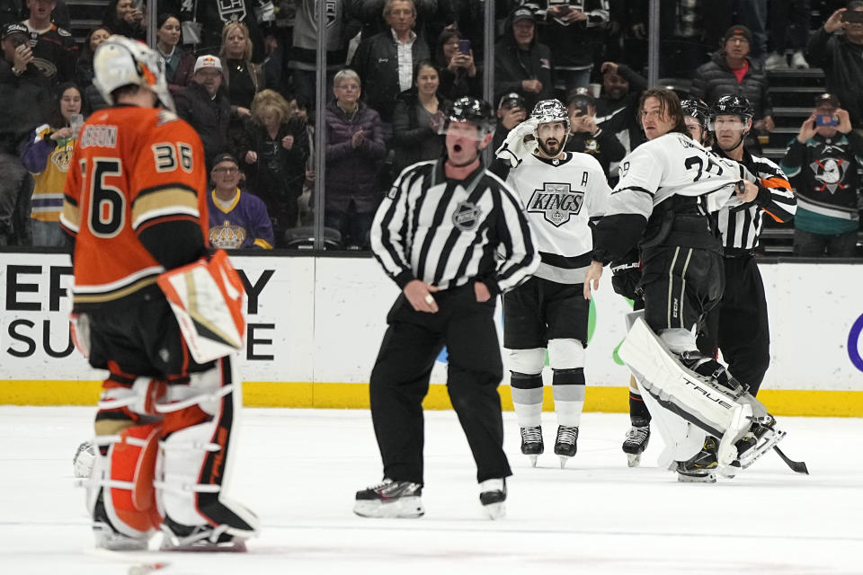 Los Angeles Kings goaltender Pheonix Copley, second from right, is held back by referee Ian Walsh, right, after Anaheim Ducks goaltender John Gibson crossed center ice during a fight in the second period of an NHL hockey game Friday, Feb. 17, 2023, in Anaheim, Calif. Copley was tossed from the game with a match penalty. (AP Photo/Mark J. Terrill)