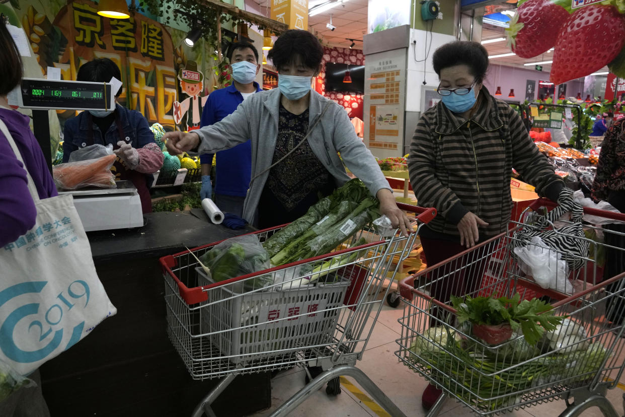 Residents wearing masks shop at a supermarket in the Chaoyang district of Beijing, Monday, April 25, 2022. Mass testing started Monday in Chaoyang district, home to more than 3 million people in the Chinese capital, following a fresh COVID-19 outbreak. (AP Photo/Ng Han Guan)