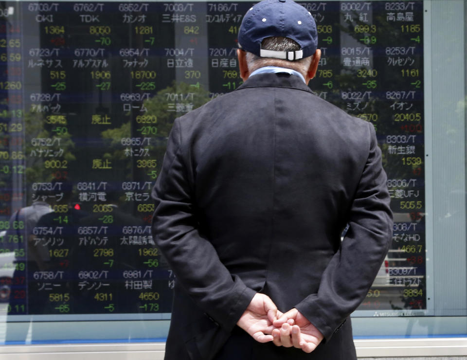 A man looks at an electronic stock board of a securities firm in Tokyo, Monday, May 20, 2019. Shares are mixed in Asia, with India and Australia leading gains following elections that look set to keep incumbents in office. (AP Photo/Koji Sasahara)