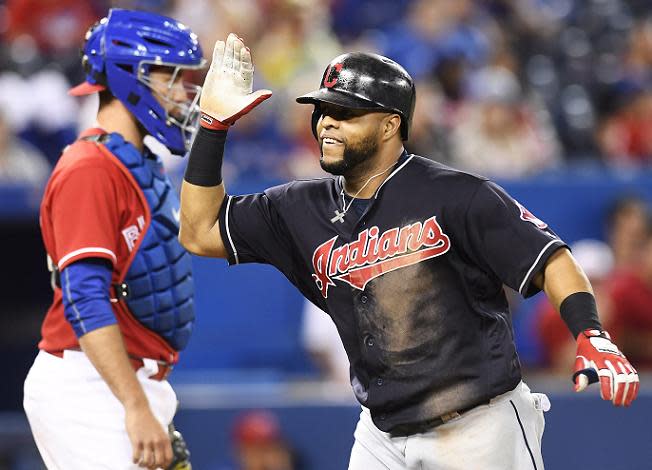 Carlos Santana celebrates his home run during the 19th inning of the Indians 2-1 win in Toronto. (AP)