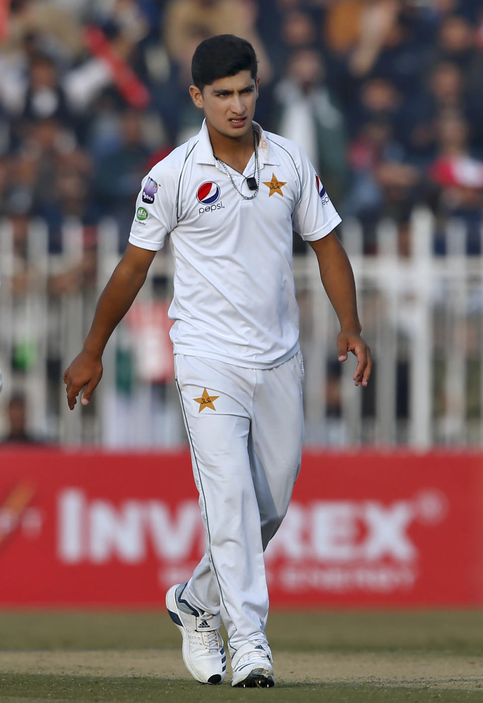 Pakistani pacer Naseem Shah walks towards his bowling point during the first-day of the 1st cricket test match between Pakistan and Sri Lanka, in Rawalpindi, Pakistan, Wednesday, Dec. 11, 2019. (AP Photo/Anjum Naveed)