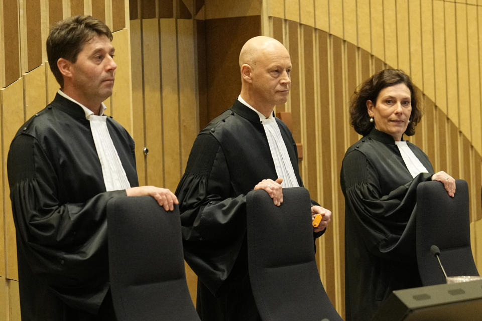 Presiding judge Hendrik Steenhuis, center, stands before the verdict session of the Malaysia Airlines Flight 17 trial at the high security court at Schiphol airport, near Amsterdam, Netherlands, Thursday, Nov. 17, 2022. The Hague District Court, sitting at a high-security courtroom at Schiphol Airport, is passing judgment on three Russians and a Ukrainian charged in the downing of Malaysia Airlines flight MH17 over Ukraine and the deaths of all 298 passengers and crew on board, against a backdrop of global geopolitical upheaval caused by Russia's full-blown invasion of Ukraine in February and the nearly nine-month war it triggered. (AP Photo/Phil Nijhuis)