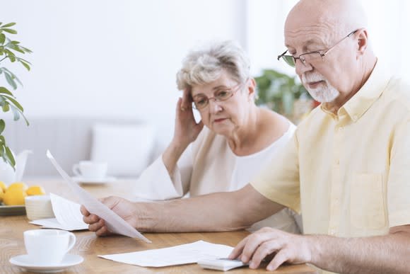 Older man and woman looking at papers