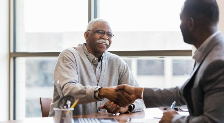 A retired man talks with his retirement advisor